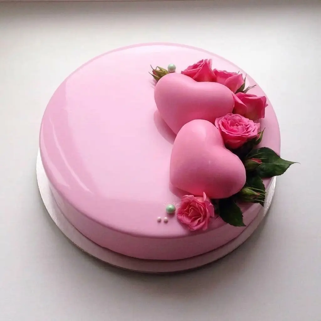 Pink celebration cake decorated with heart details and pink roses